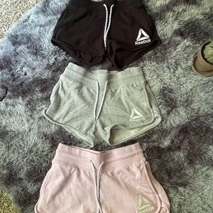 Black, pink, and gray Reebok shorts